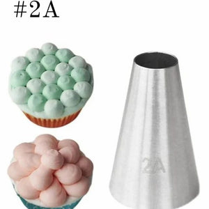 Baking tool with number 2A next to cupcakes decorated with similar shapes on a white background