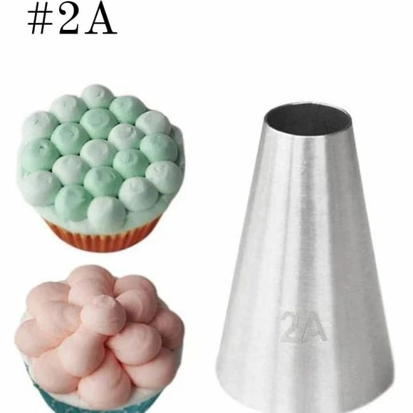 Baking tool with number 2A next to cupcakes decorated with similar shapes on a white background