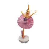 Ballet dancer figurine with pink skirt on a gray background