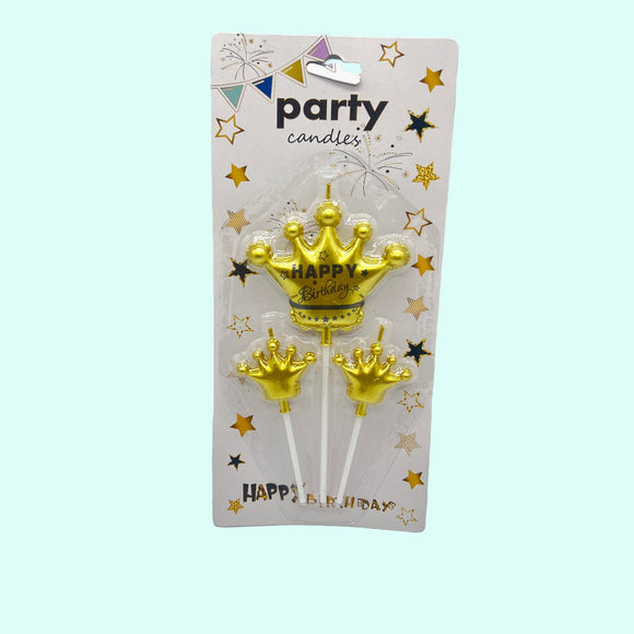 Gold crown-shaped birthday candles on a 'party candles' packaging with stars and 'Happy Birthday' text.