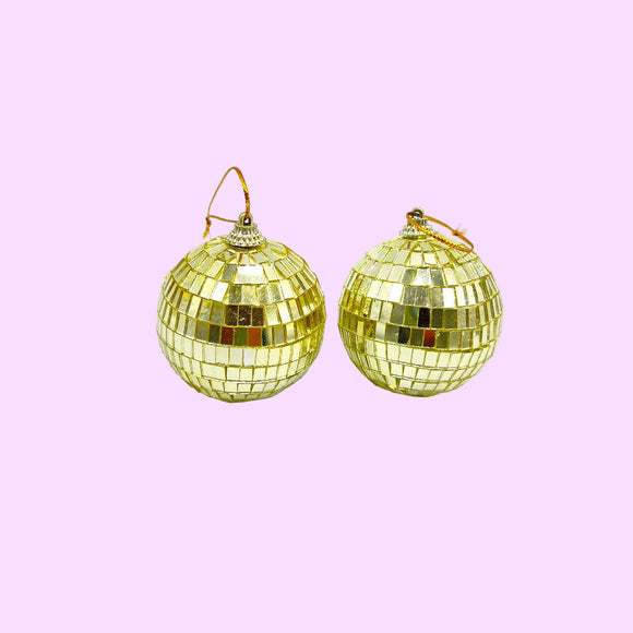Gold disco ball earrings on a white background