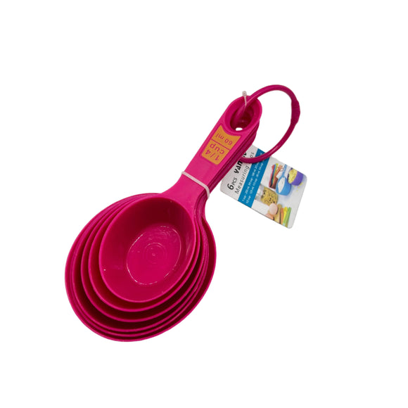 Set of pink measuring cups with a tag on a white background